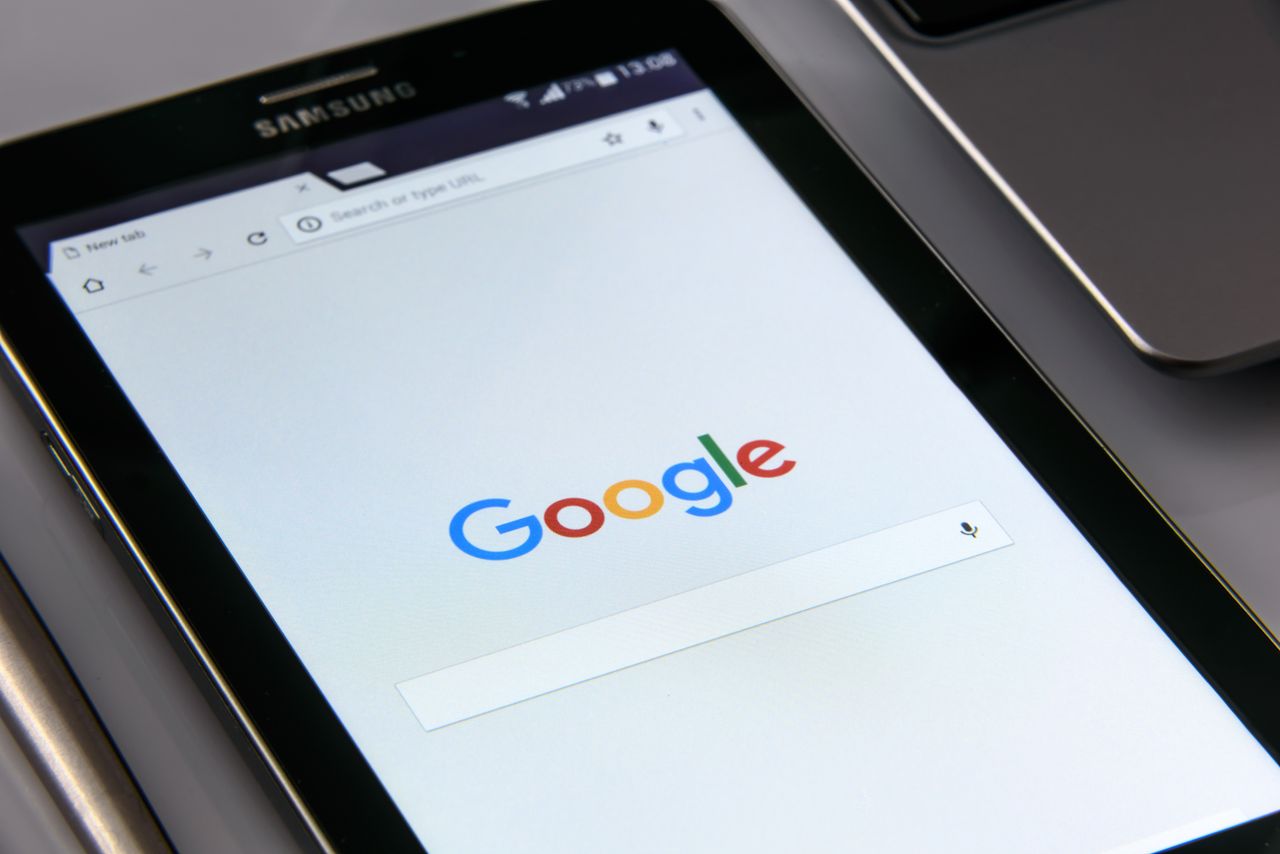 Services-01 Close-up of a tablet displaying Googles search screen, emphasizing technology and internet browsing.